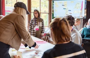 Attendees engaged in a group activity around a table